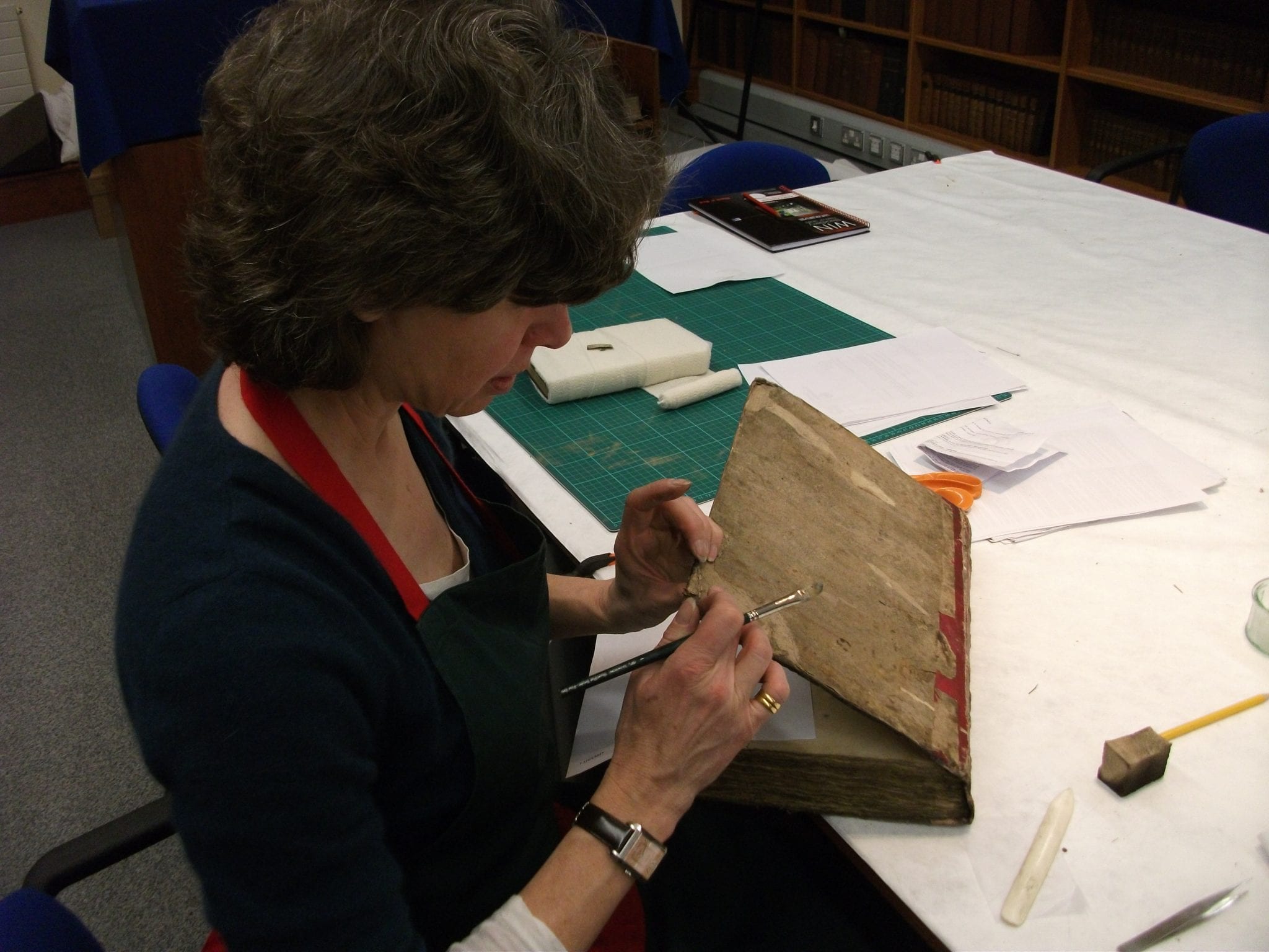 Caroline Bendix demonstrating basic repair on a  18th century Dutch binding