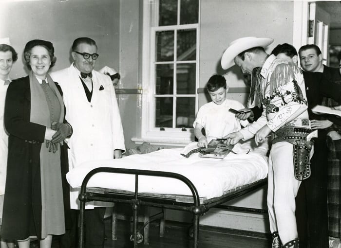 Roy Rogers with a patient at Mearnskirk Hospital, 1954