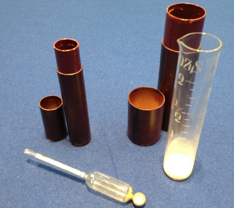 A urinometer and measuring cylinder. Used to test the specific gravity of urine, this device is helpful in assessing the amount of sugar present in a urine sample.