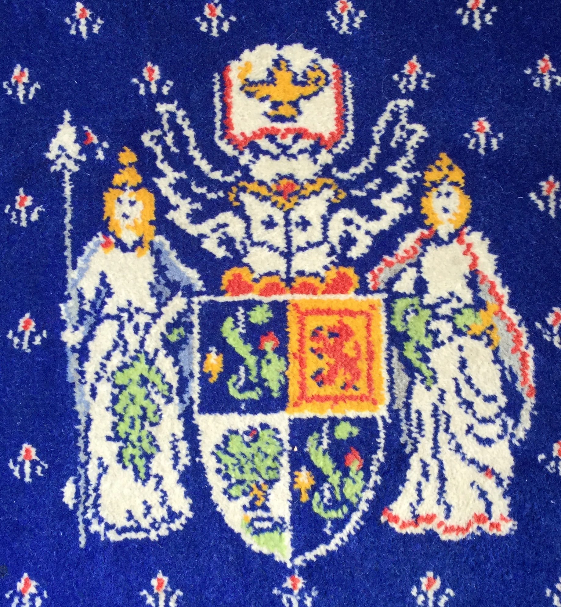 Logo of the College featured on the Lock Room carpet